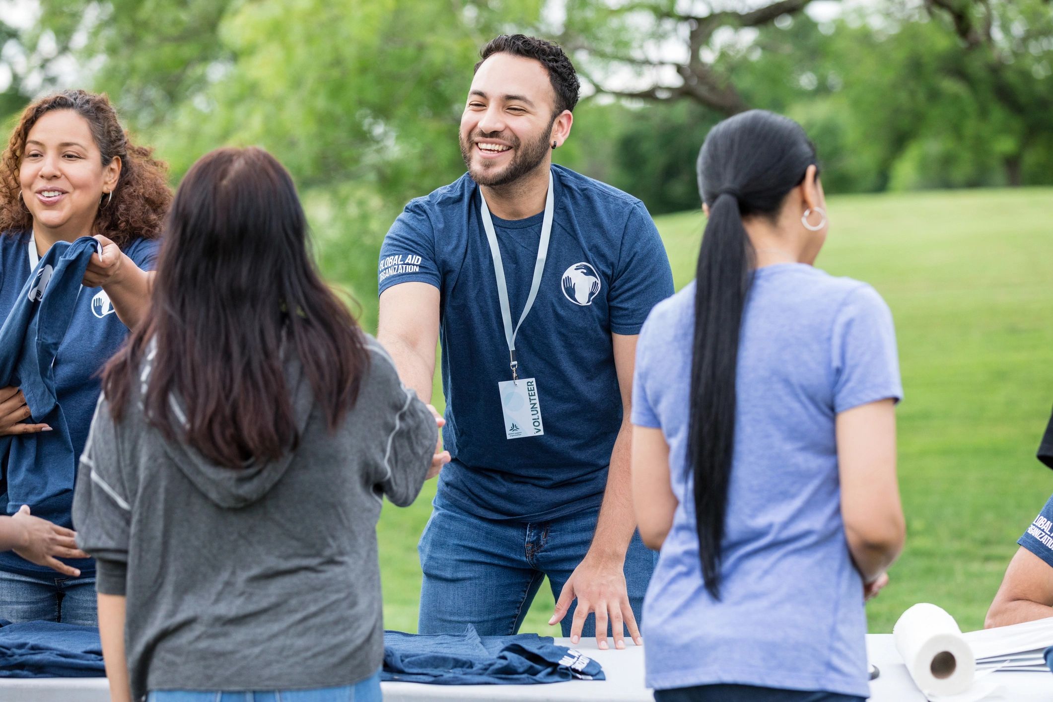 Volunteer welcoming a community member at a park